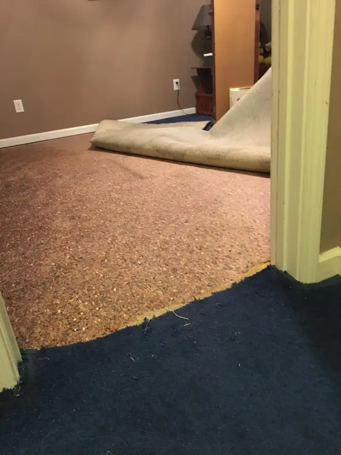 Carpet pad removal revealing water damage during Drying & Dehumidification in Brawley